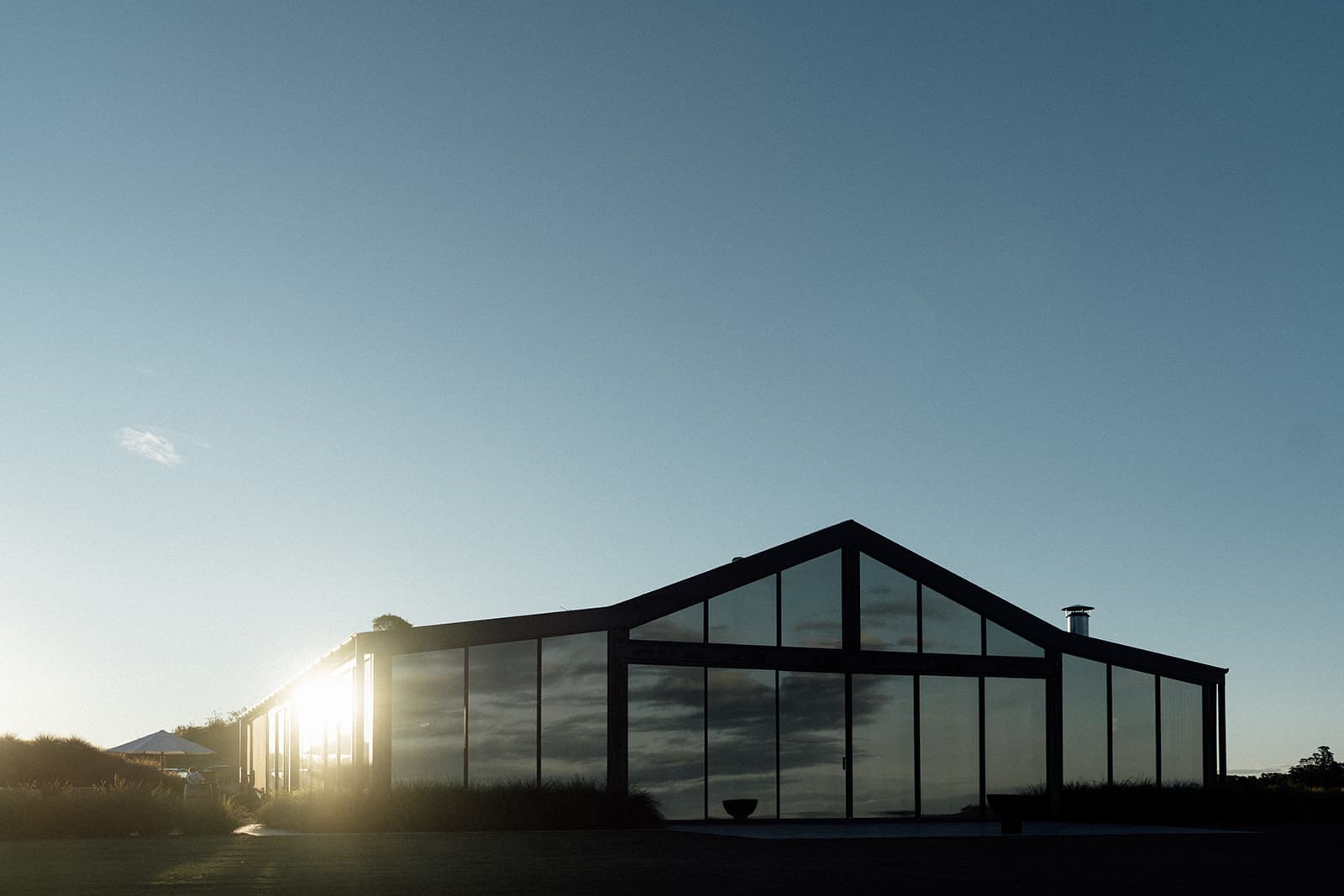 The glass Pavilion at dusk, evening sky reflected in its gabled glass walls